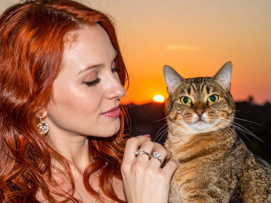 Women with a diamond ring on her finger next to a golden cat 414493